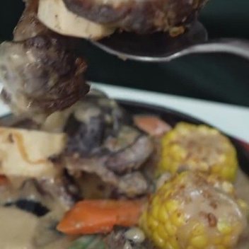 Bulalo: beef shank and bone marrow ladled over corn and carrot