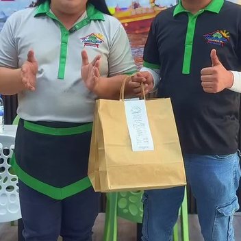 Two of the team with a packed takeaway order