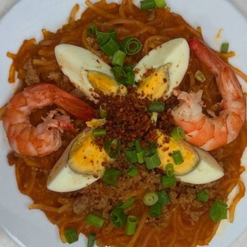 Pancit Malabon with prawns, boiled egg and toasted garlic