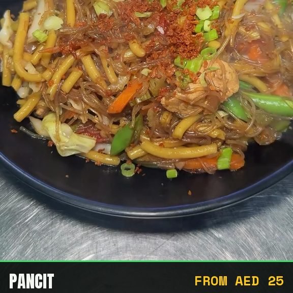 Pancit plated with toasted garlic and spring onion