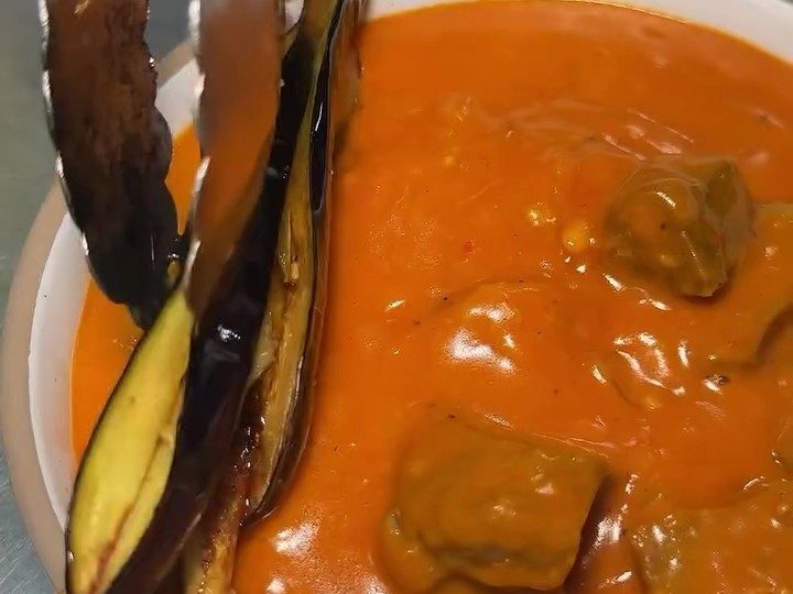 Beef in a thick peanut sauce with whole aubergine, the Filipino kare kare