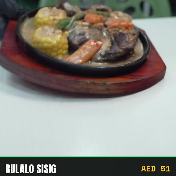 Bulalo sisig on a sizzling plate with sweet corn and carrot
