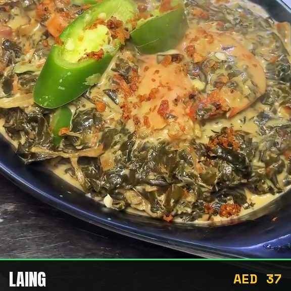 Laing simmering: taro leaves in coconut milk with prawns and green chilli