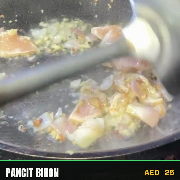 Pancit cooking in the wok, noodles going in last