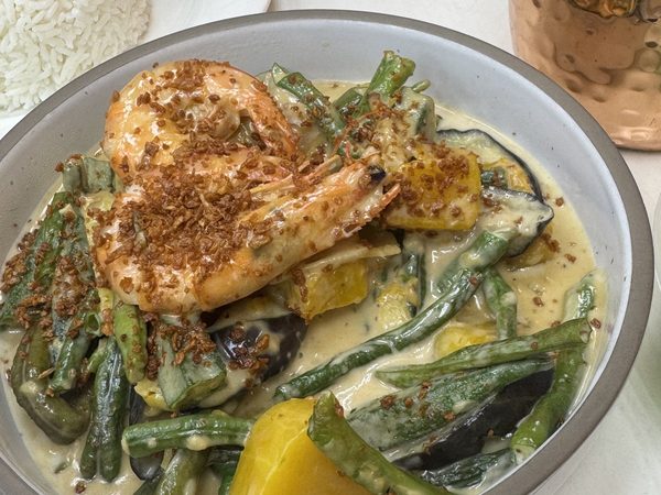 Ginataang gulay with prawns in coconut cream, with string beans, eggplant and squash topped with fried garlic, served beside steamed rice