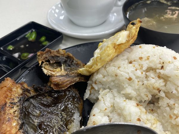 Daing na bangus silog: crispy fried milkfish with garlic fried rice, a fried egg, a bowl of soup and a latte